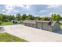 Large multi-car garage with overhead doors and adjacent tennis court, creating ample space for recreation and storage at 2370 W 152Nd Ave, Broomfield, CO 80023