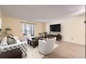 Cozy living room with natural light, neutral decor, sliding door and modern furnishings at 3124 S Wheeling Way # 102, Aurora, CO 80014