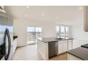 Kitchen featuring stainless steel appliances and a spacious center island with a sink, and hardwood floors at 5601 Inland Ave, Firestone, CO 80504