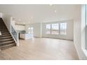 Bright and airy living room with hardwood floors, recessed lighting, and large windows offering scenic views at 5601 Inland Ave, Firestone, CO 80504