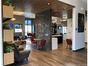 Stylish lounge area featuring modern furnishings, wood floors and a decorative divider at 5601 Inland Ave, Firestone, CO 80504