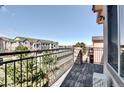 Open balcony showcasing neighborhood view and dark metal railing at 3155 E 104Th Ave # 4E, Thornton, CO 80233