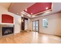 Open living area with hardwood floors, fireplace, and sliding glass doors to outdoor area at 3155 E 104Th Ave # 4E, Thornton, CO 80233