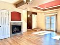 Bright living room featuring a cozy fireplace and sliding doors to the outdoor balcony at 3155 E 104Th Ave # 4E, Thornton, CO 80233