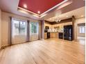 Open-concept living and dining area with hardwood floors and stainless steel appliances in kitchen at 3155 E 104Th Ave # 4E, Thornton, CO 80233