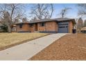 Attractive single story brick home features a lengthy driveway, and attached garage at 725 S Harrison St, Denver, CO 80209