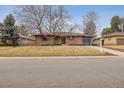 Lovely brick home with an attached garage and a mature tree in the front yard at 725 S Harrison St, Denver, CO 80209