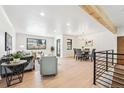 Open concept living and dining area with hardwood floors and a modern aesthetic at 725 S Harrison St, Denver, CO 80209