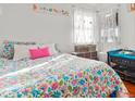 Charming bedroom featuring floral bedding, soft white walls, and bright light at 1315 Xanthia St, Denver, CO 80220