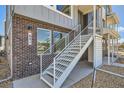 Exterior view of stairway that leads to the second floor entrance of this townhome, with nice window details at 641 Skyhook St, Erie, CO 80516