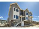 Charming two-story townhome featuring modern architecture and inviting entry with stairway to a second floor unit at 641 Skyhook St, Erie, CO 80516