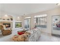 Cozy living room with fireplace, arched shelving, and sliding doors to balcony, creating a warm and inviting space at 10050 E Gunnison Pl # 805, Aurora, CO 80247