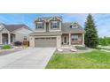 Beautiful two-story home with a well-maintained lawn, stone details, and a convenient two-car garage at 5625 S Buchanan St, Aurora, CO 80016