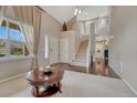 Welcoming foyer with high ceilings, elegant staircase, hardwood floors, and an abundance of natural light at 5625 S Buchanan St, Aurora, CO 80016