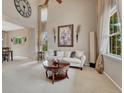 Bright living room with high ceilings, large windows, neutral color scheme, and stylish decor at 5625 S Buchanan St, Aurora, CO 80016