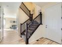 Home entryway and staircase with wood floors and neutral walls at 8562 E 49Th Pl, Denver, CO 80238