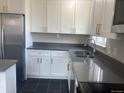 Modern kitchen features stainless steel appliances, sleek gray countertops, and ample cabinet space at 1326 S Canosa Ct, Denver, CO 80219
