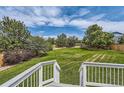 Spacious backyard with a large, well-maintained lawn and mature trees at 3416 Hawthorne Dr, Highlands Ranch, CO 80126