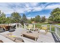 Inviting outdoor deck with stylish patio furniture and a scenic backyard view at 3416 Hawthorne Dr, Highlands Ranch, CO 80126