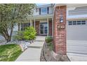 Inviting home entrance with stone landscaping, covered porch, and updated address numbers at 3416 Hawthorne Dr, Highlands Ranch, CO 80126