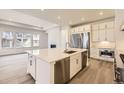 Modern kitchen features a large island with stainless steel appliances and plenty of cabinet space at 15586 W Beloit Ave, Morrison, CO 80465