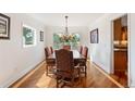 Elegant dining room featuring a chandelier, hardwood floors, large window and seating for six at 19052 E Briarwood Dr, Centennial, CO 80016