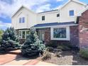Charming two-story home with brick and siding, beautiful front garden and mature trees at 19052 E Briarwood Dr, Centennial, CO 80016