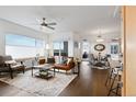 Bright living room featuring a stylish leather sofa, dining area, and large window with scenic views at 1585 Hecla Way # 201, Louisville, CO 80027