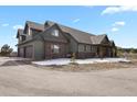 Lovely two-story home featuring a spacious three car garage and lush landscaping at 5800 Elk View Ct, Larkspur, CO 80118