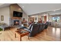 Cozy living room featuring a stone fireplace and hardwood floors at 5800 Elk View Ct, Larkspur, CO 80118