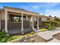 Inviting front porch with brick accents, pillars, and lovely landscaped features at 9598 Lowell Blvd, Westminster, CO 80031