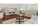 Spacious living room with hardwood floors, recessed lighting, and windows providing ample natural light at 909 N Logan St # 1B, Denver, CO 80203