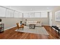 Inviting living room with hardwood floors, a comfortable sofa, and an abundance of natural light at 909 N Logan St # 1B, Denver, CO 80203