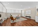 Bright living room featuring hardwood floors, recessed lighting, a white couch, and a decorative area rug at 909 N Logan St # 1B, Denver, CO 80203