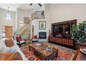 Great room featuring a fireplace, staircase, large windows, and comfortable seating at 35 Brookhaven Pl, Littleton, CO 80123