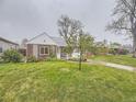 Charming single-story home featuring a well-kept lawn and inviting front entrance at 5703 Ammons St, Arvada, CO 80002