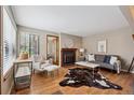 Comfortable living room showcasing a fireplace, hardwood floors, and an abundance of natural light at 840 S Vance St # A, Lakewood, CO 80226