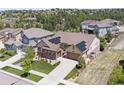 Expansive aerial shot of a home with solar panels, a landscaped yard, and a private fenced-in area at 8142 S Langdale Way, Aurora, CO 80016