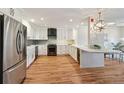 An open concept kitchen with stainless steel fridge and dark appliances at 1780 N Washington St # 203, Denver, CO 80203