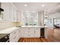 An open kitchen with sleek white cabinets and eat-in counter at 1780 N Washington St # 203, Denver, CO 80203