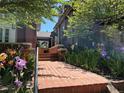 Brick home with lush landscaping and a brick walkway leading to the entrance at 724 N Franklin St, Denver, CO 80218