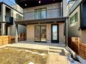 Close up of a modern townhouse with a covered porch and rooftop deck above at 1234 N Tennyson St, Denver, CO 80204