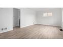 Spacious room featuring wood-look floors, bright walls, and a large window at 1225 S Xavier St, Denver, CO 80219