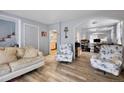 Cozy living room with hardwood floors, comfortable seating, and an open doorway at 902 Virginia St, Idaho Springs, CO 80452
