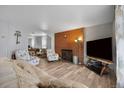 Spacious living room featuring a brick fireplace, hardwood floors, and comfortable furniture at 902 Virginia St, Idaho Springs, CO 80452