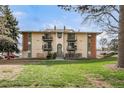A charming two-story apartment building featuring multiple balconies and an inviting facade at 12113 Melody Dr # 304, Denver, CO 80234