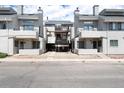 Exterior shot of condominium buildings with balconies and ground level covered parking, and a central staircase at 1830 Newland Ct # 321, Lakewood, CO 80214