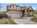Charming two-story home with a two-car garage and a welcoming brick-accented entryway at 10288 Salida St, Commerce City, CO 80022