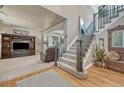 Spacious entryway featuring hardwood floors, staircase, and living room access at 1410 Old Sequoia Ct, Franktown, CO 80116