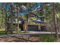 Beautiful two-story home with stone accents and a lush surrounding landscape at 1410 Old Sequoia Ct, Franktown, CO 80116